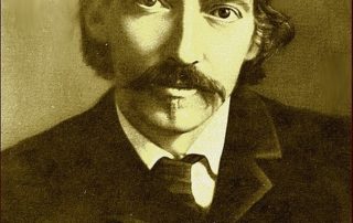 This photograph was taken in the 1880's and shows famous author and poet, Robert Louis Stevenson. it is a portrait photo showing his head and shoulders. He is looking directly at the camera. The photo was taken by James Notman. Robert Louis Stevenson has a long moustache and has a dark jacket, white shirt and a tie on.